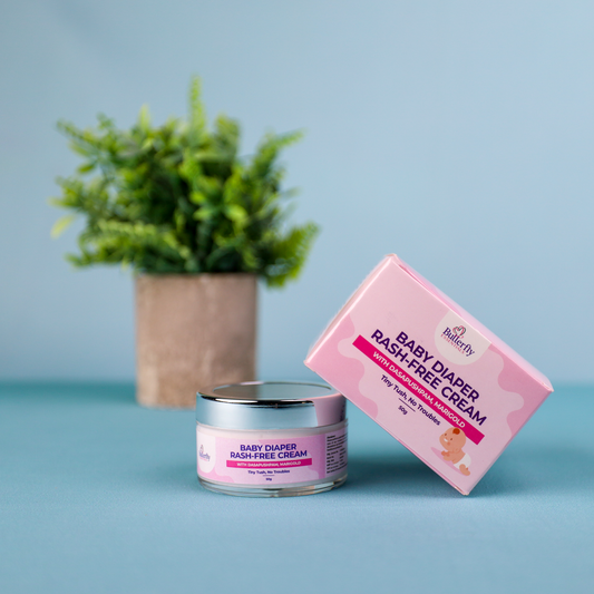 Baby diaper rash-free cream jar and box on a blue surface with a plant in the background