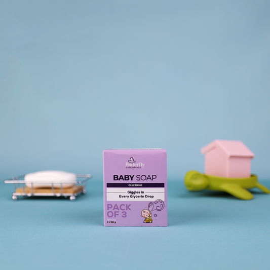Purple box of baby soap with two bars of soap on a blue background