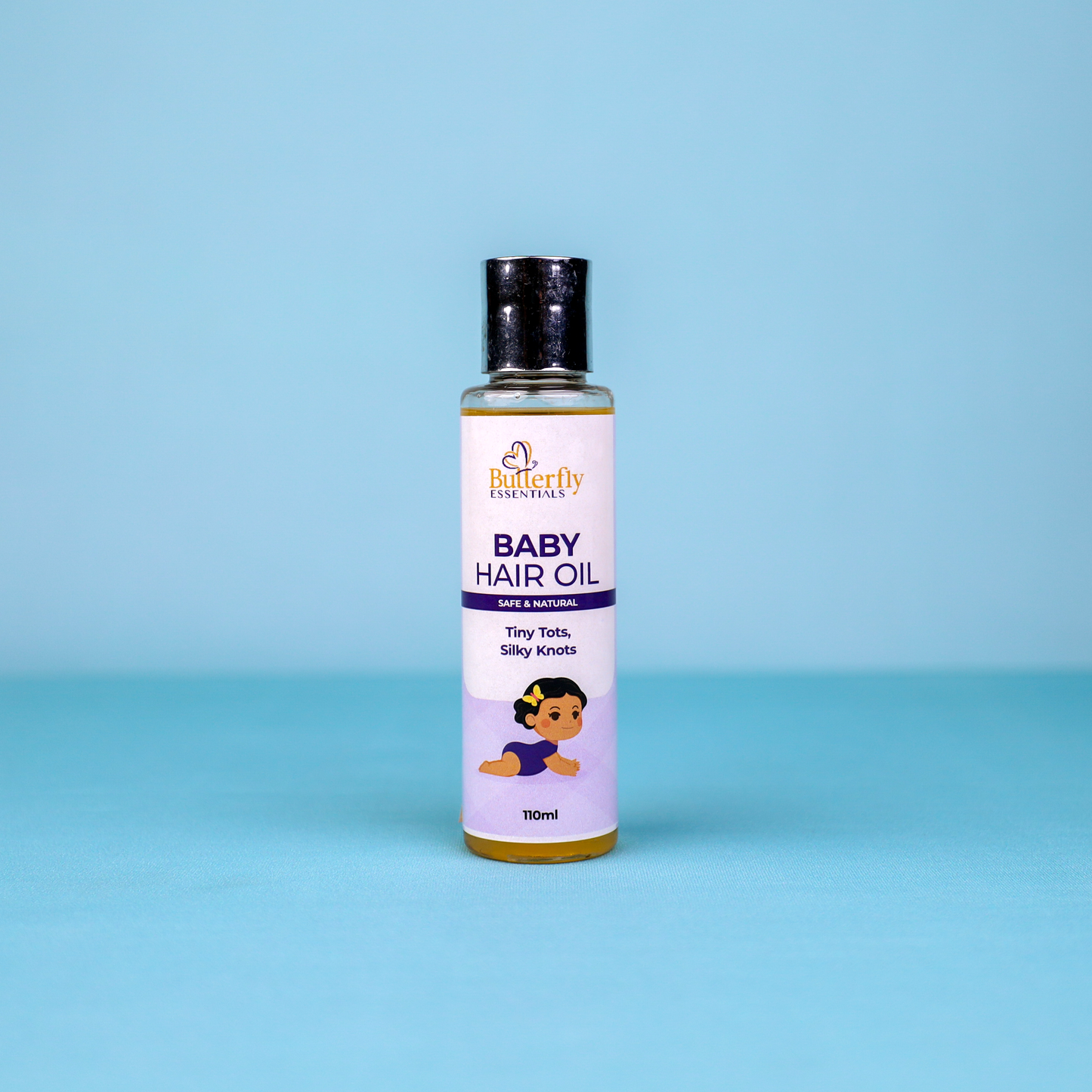 A baby hair bottle of butterfly essentials on a blue background.