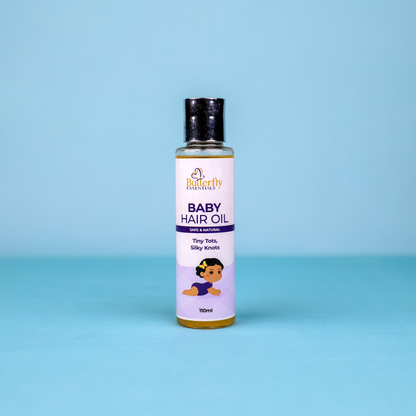 A baby hair bottle of butterfly essentials on a blue background.