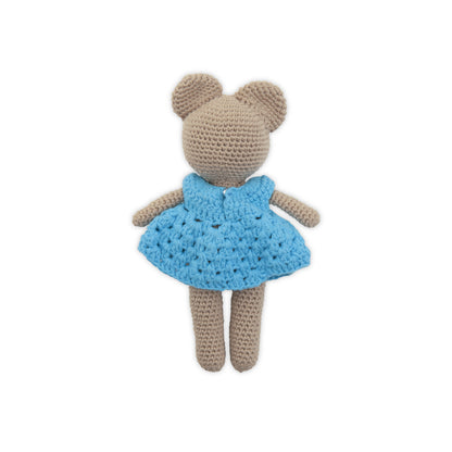 Crocheted teddy bear with a blue dress on a white background